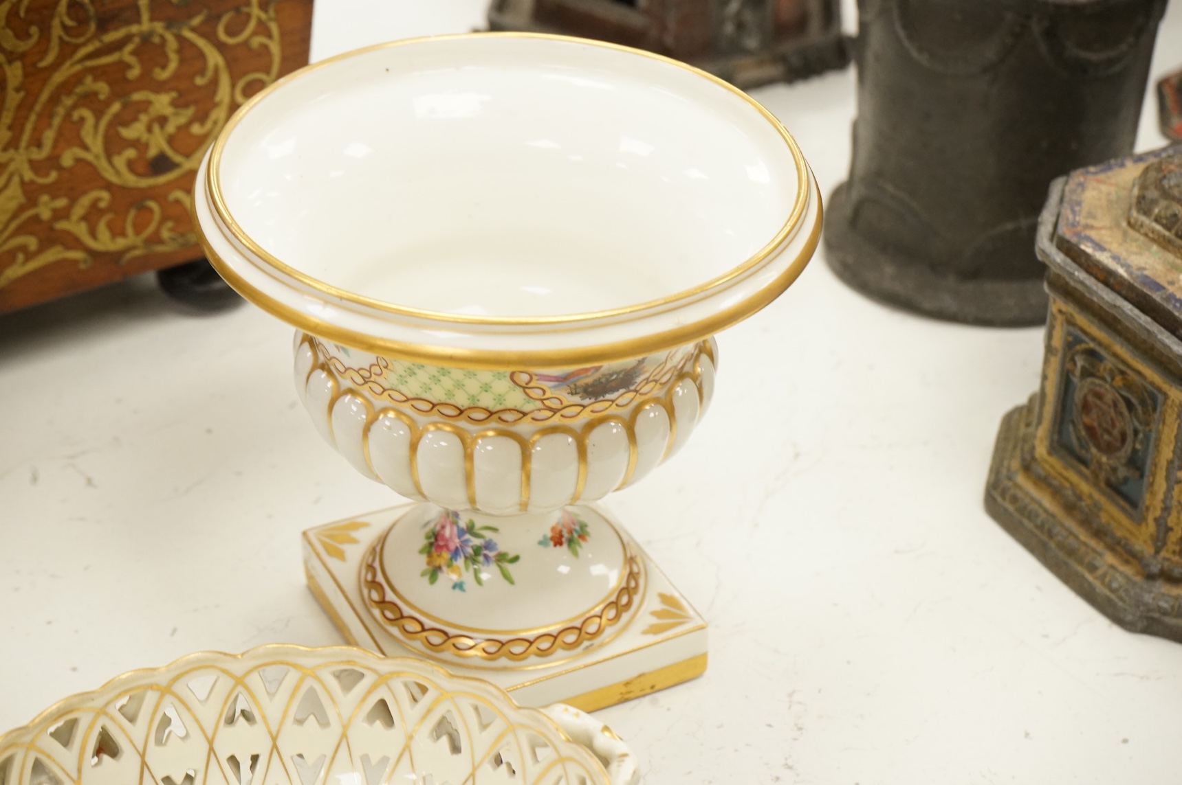 A pair of Dresden urns and a floral encrusted basket, tallest 15cm